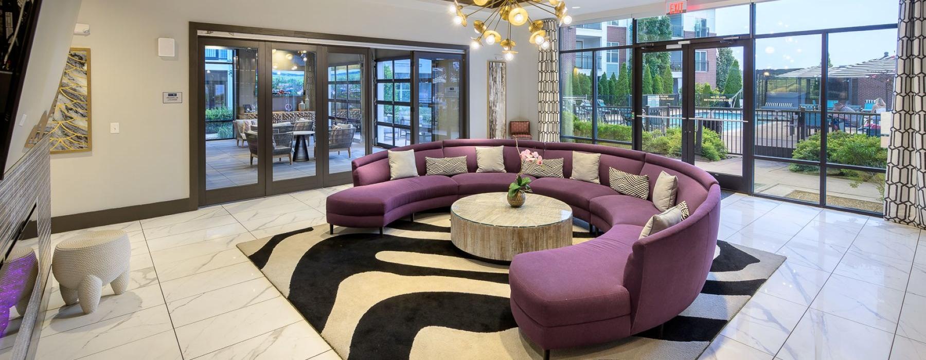 a room with a large chandelier and a couch