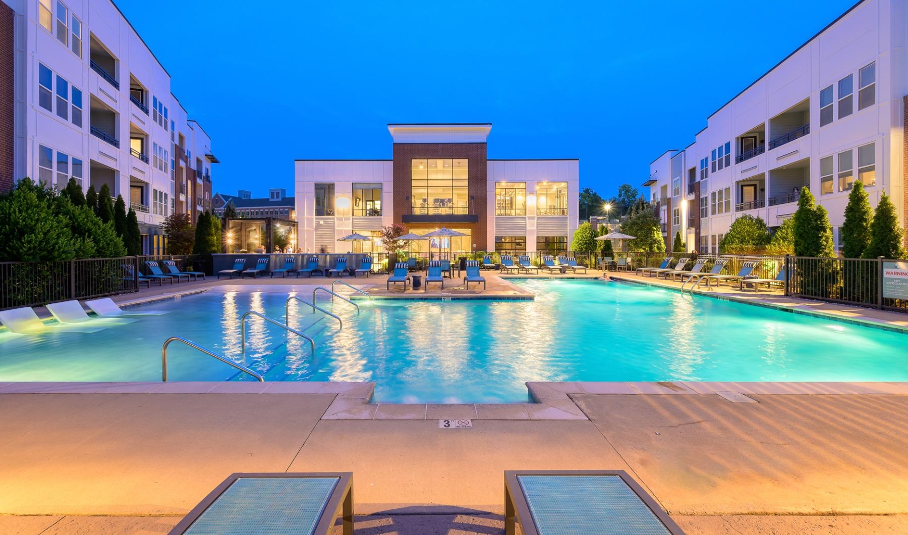 a swimming pool in a courtyard between buildings